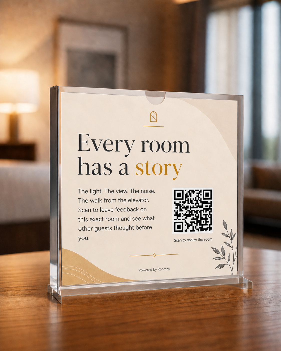 Acrylic tabletop sign in a hotel room with a QR code reading 'Every room has a story'